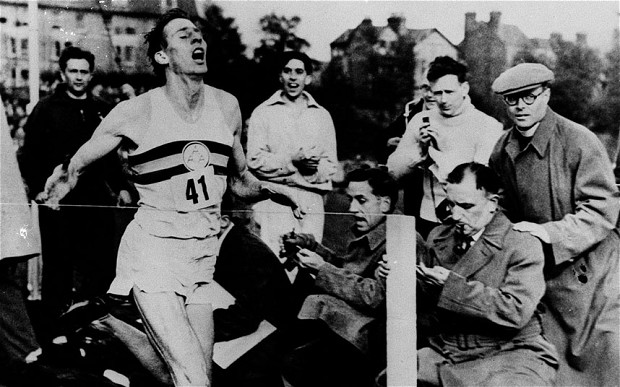 Roger Bannister hits the tape after running the first four-minute mile